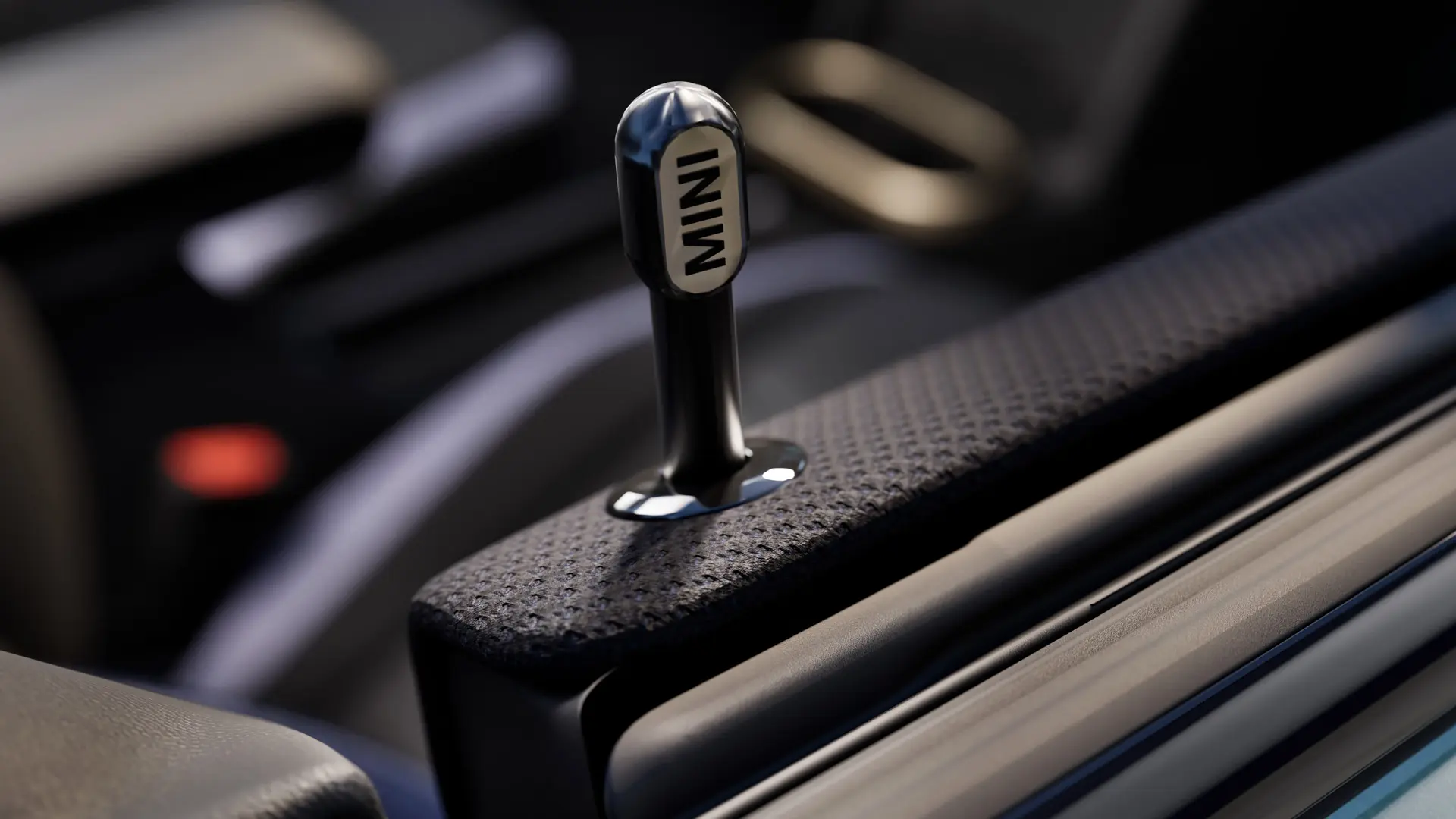 Close up of Genuine MINI interior door locking pin in black anodised aluminum.