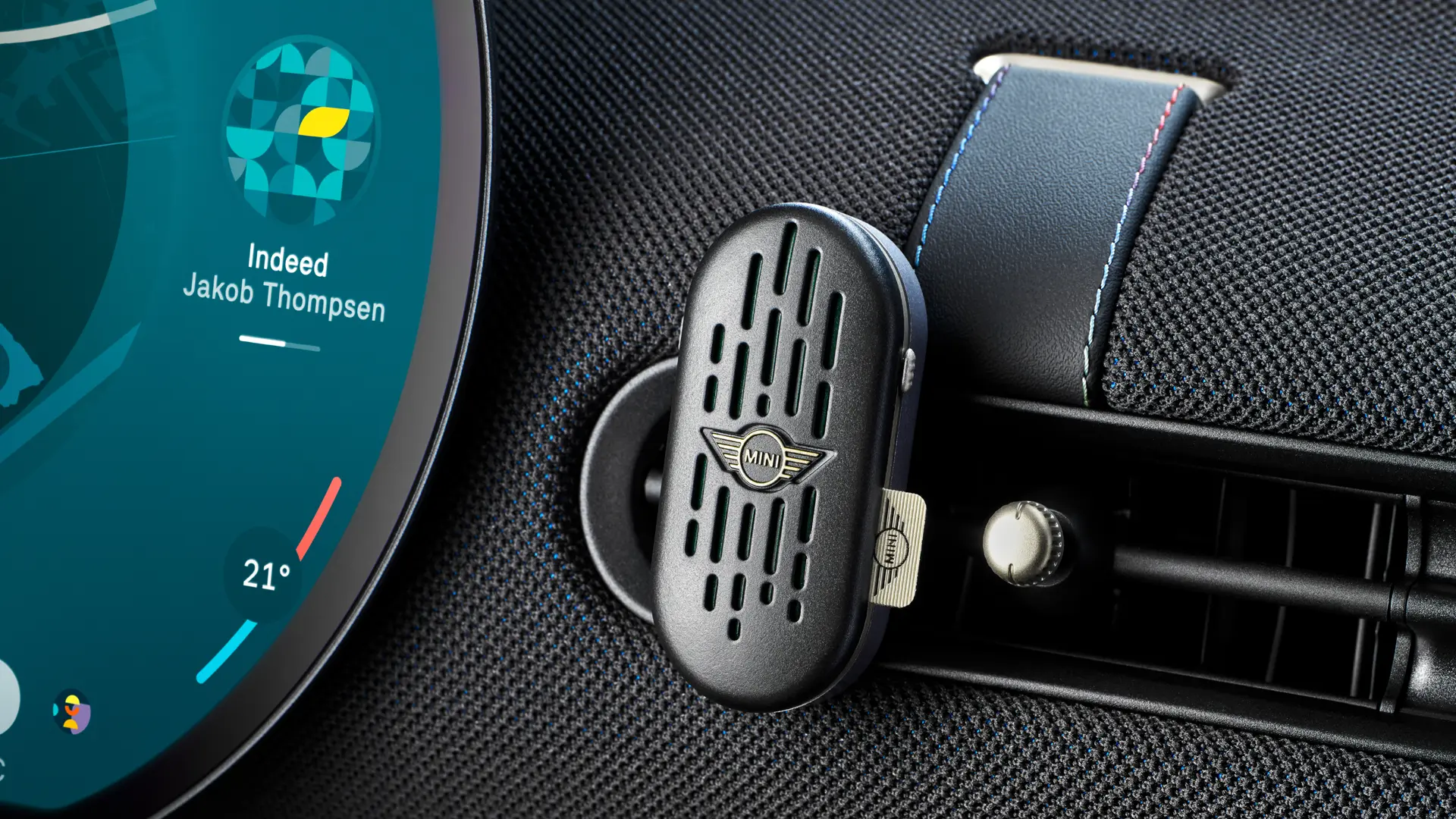 MINI Aceman interior with circular OLED infotainment touchscreen and MINI natural air freshener on dash